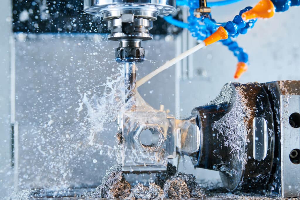 CNC-Fräsmaschine die mit eingeschalteten Kühlmittel ein Bauteil bearbeitet. – CAM-Bearbeitung mit CAMWorks für SOLIDWORKS